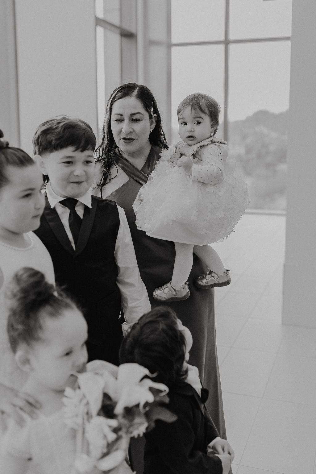 Flower girls and ring bearer with family, black and white